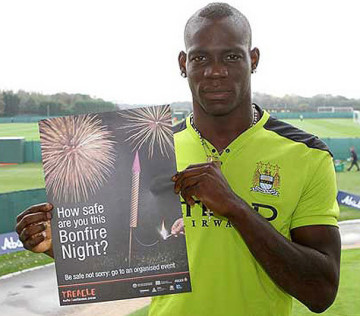 Crazy Balotelli ironically poses with fireworks!
